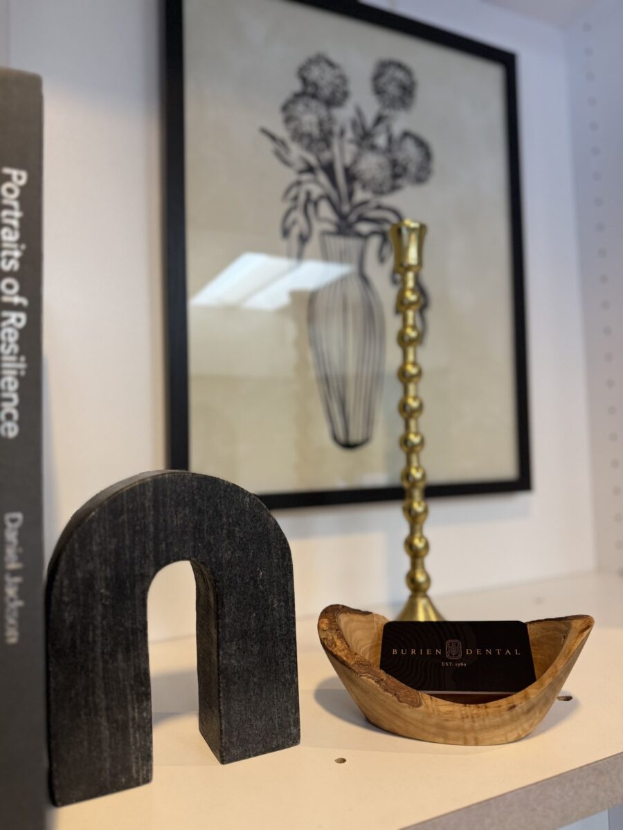 Decorative shelf with artwork and Burien Dental business cards.