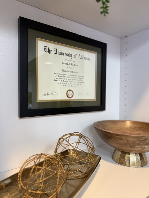 University diploma displayed on decorative shelf inside Burien Dental office.